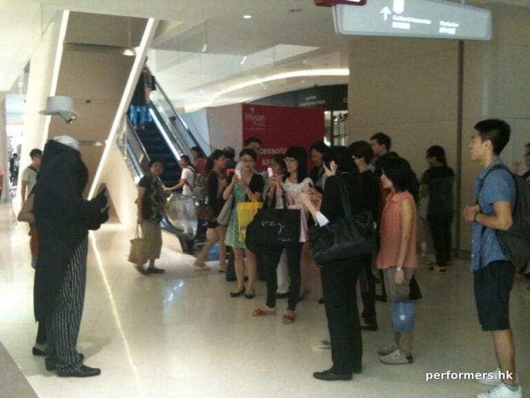 Headless man living state performing at a mall