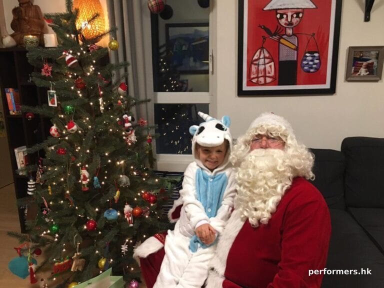 santa pete having a child sit on his lap during santa home visit