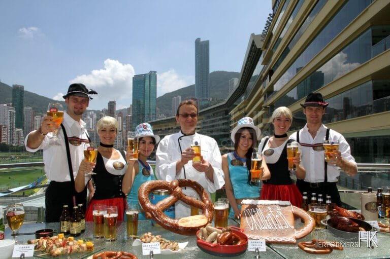 Four dancers in Hong Kong wearing German traditional costume posing for the Hong Kong Jockey Club Oktoberfest event