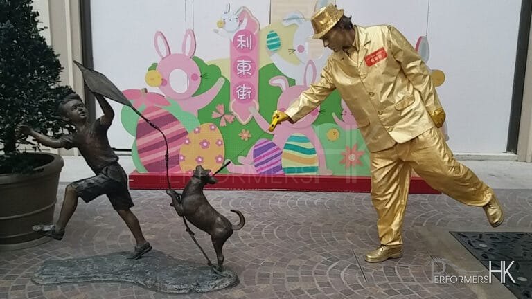 golden statue walking bronze statue dog