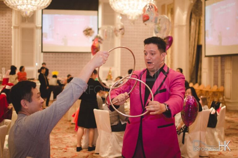 Hong Kong magician performing table magic three linking rings to a gentlemen at a children birthday party at Hong Kong Aberdeen marina club