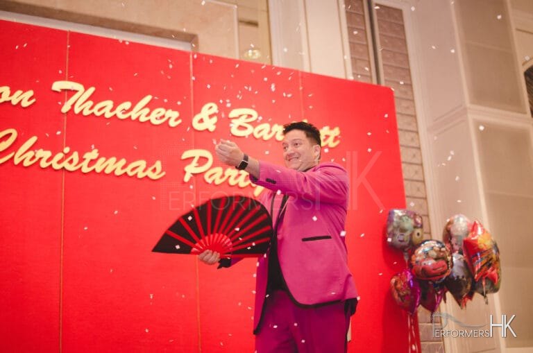 Magician performing snow storm magic trick with a fan at a corporate Christmas party at Aberdeen Marnia Club Hong Kong