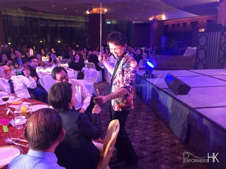 Roving magician in Hong Kong performing roving magic to CEO with wine at annual dinner