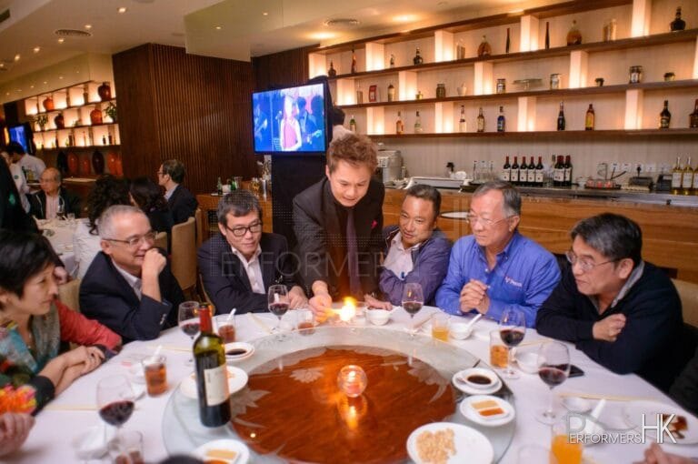 Magician in Hong Kong performing table roving magic at a corporate annual dinner