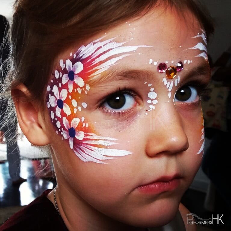 little girl with face painted flower on face