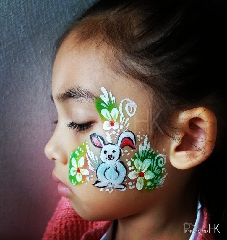 Girl with face painted easter bunny.