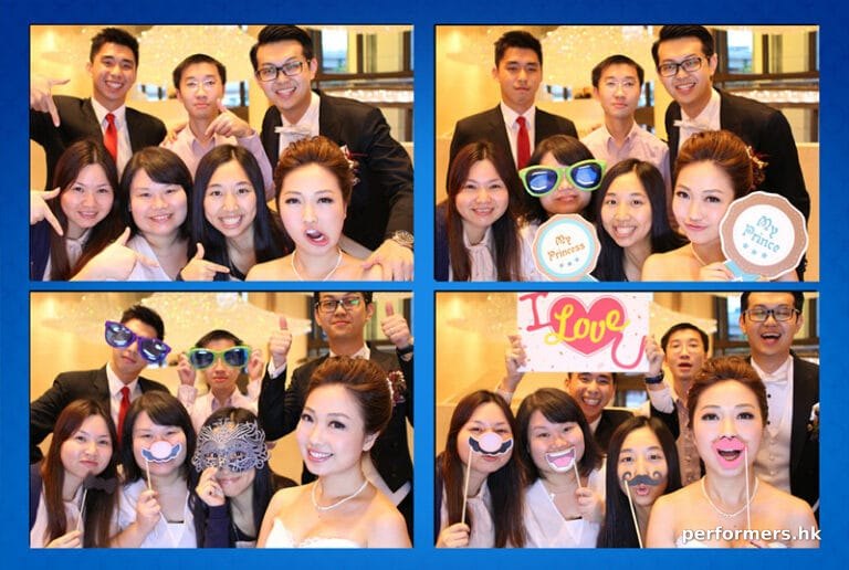 male and female guests taking photos with photobooth team props