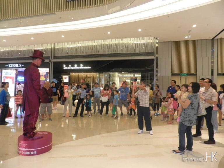 Purple Living State performing in shopping center with crowd behind