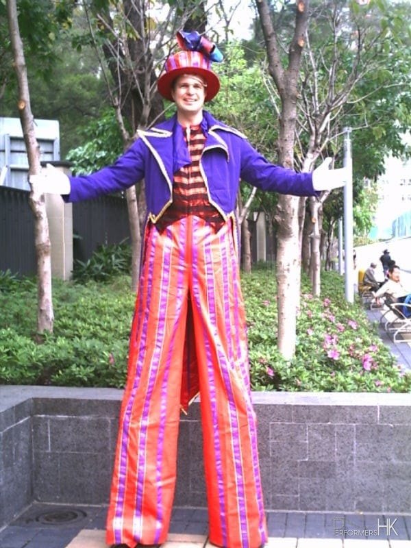 Hong Kong Stilt-walker wearing a purple and pink costume at a school event