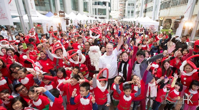 Group photo of large group of Santa helpers with santa in the middle
