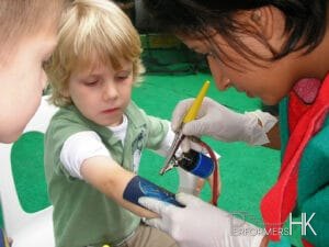 The Temporary tattoo artist in Hong Kong spraying a tattoo on a child arm
