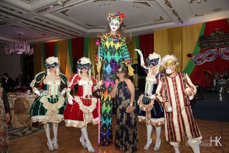 Hong Kong professional stiltwalker in Venetian LED costume posing with three Maries Marionette dancers and juggler at a corporate Masquerade theme annual dinner