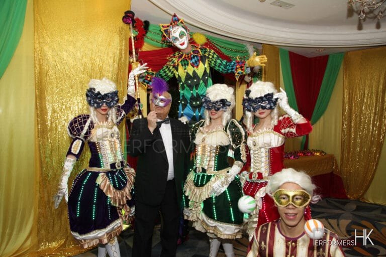 Stiltwalker in Venetian LED costume posing with three Maries Marionette dancers and juggler at a Hong Kong corporate Masquerade theme event