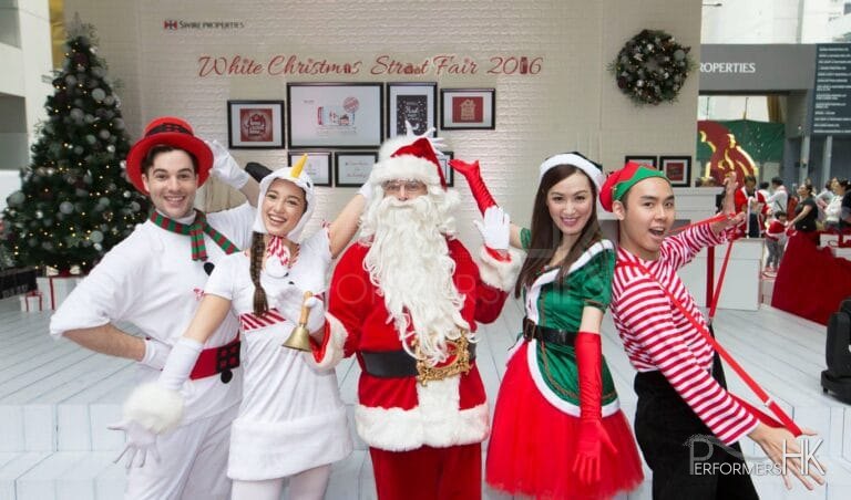 santa taking a photo with elf and snowman character in hong kong