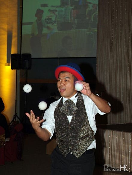Clown in Hong Kong juggling 3 balls at a corporate event