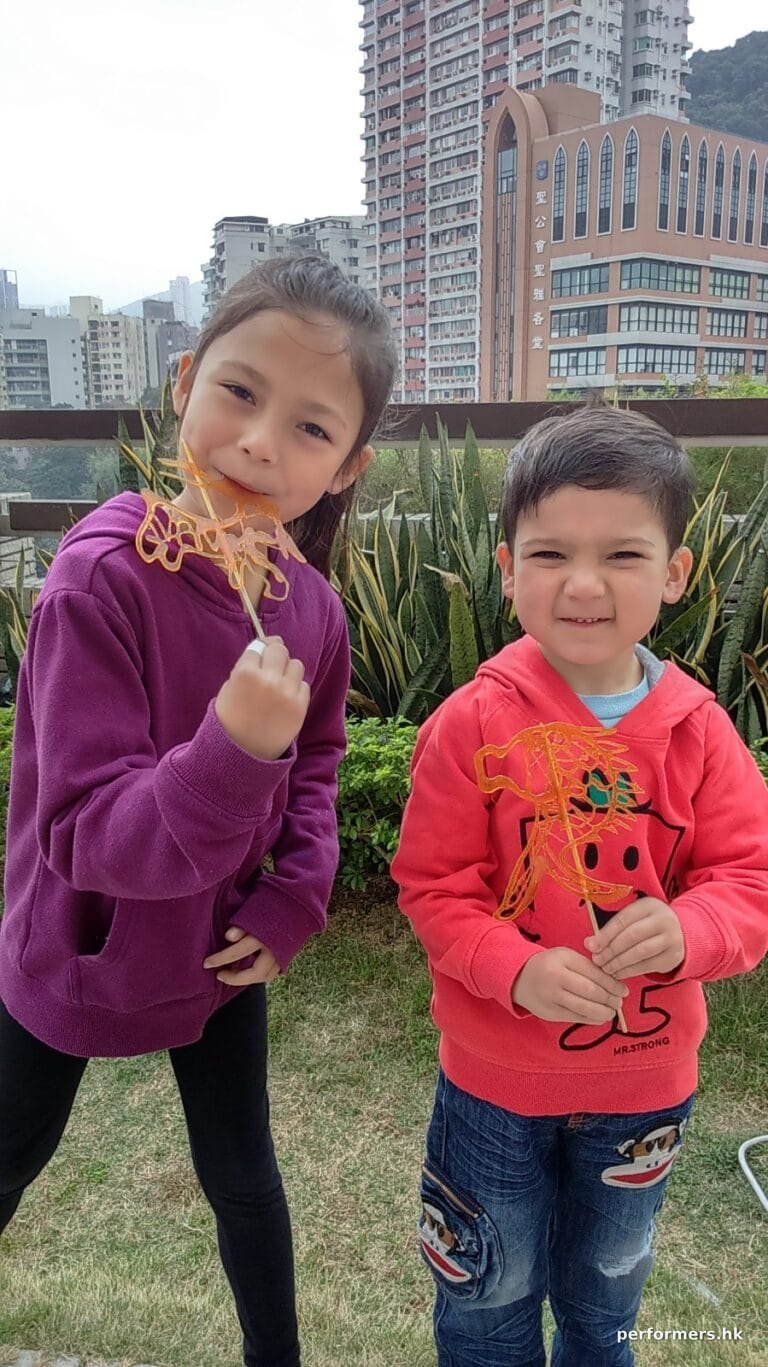2 young children with Sugar painting (糖画) at event