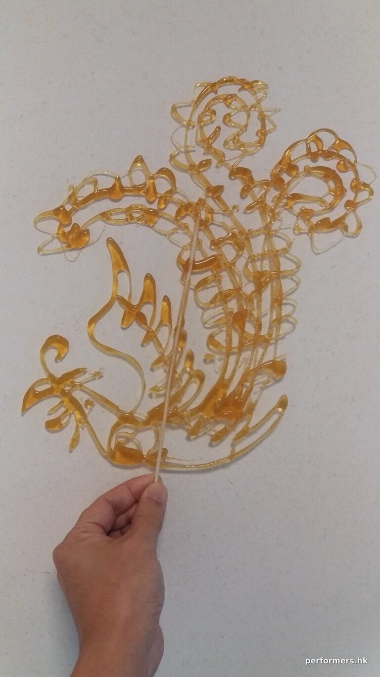 work by artist at an event of pheonix shaped Sugar painting (糖画)