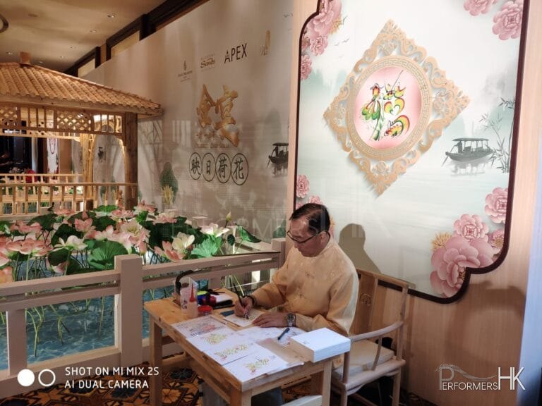 Event artist in macau doing rainbow calligraphy in white chinese costume